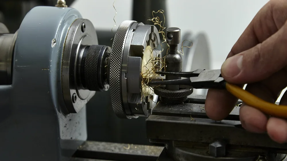 A part being turned on a lathe in the Garrick workshop